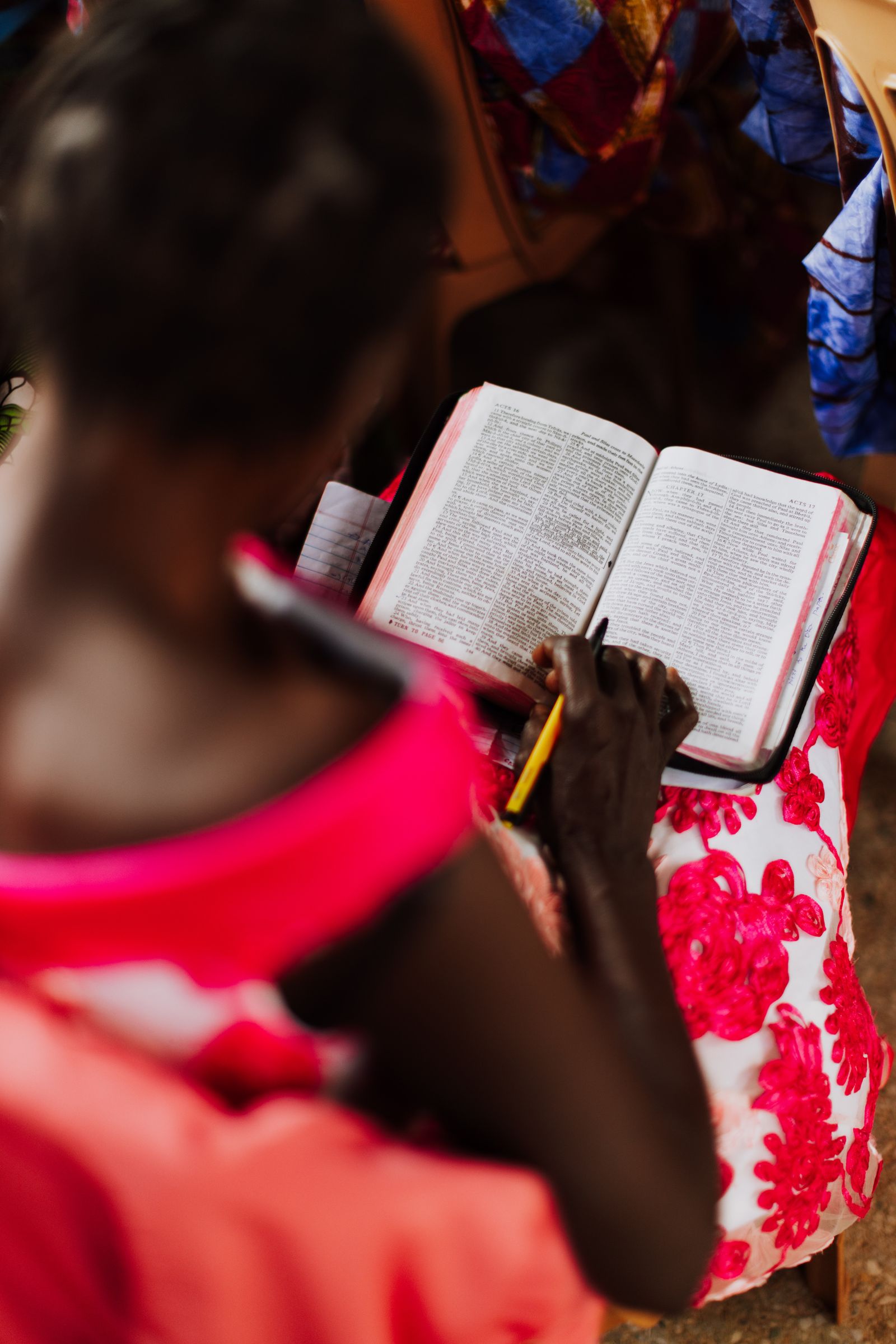 A woman reading and studying her Bible with a pencil during quiet devotional time